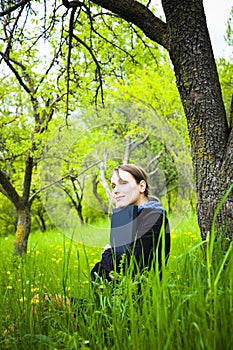 Woman with laptop in field