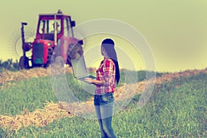 Woman with laptop in the field