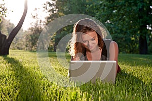 Woman with laptop on the grass