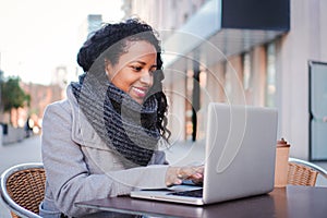 Woman with a laptop happy to work outdoors while having a business online meeting, young lady smiling and working in a