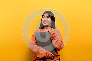 woman and laptop and are happy to work Photo of a beautiful Asian woman who is happy working at home. using a laptop