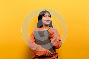 woman and laptop and are happy to work Photo of a beautiful Asian woman who is happy working at home. using a laptop