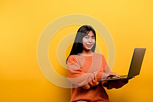 woman and laptop and are happy to work Photo of a beautiful Asian woman who is happy working at home. using a laptop