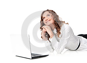 Woman with laptop lying down on the floor