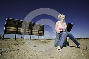 Woman with a laptop ourdoors