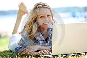 Woman on laptop outside