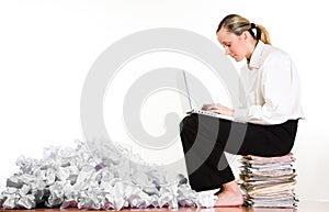 Woman, laptop and paperwork