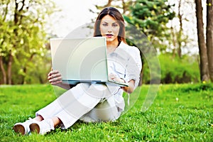 Woman with laptop in park