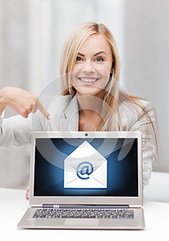 Woman with laptop pointing at email sign