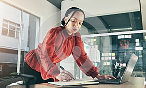 Woman on laptop, research and writing notes, ideas on website for business plan or brainstorming proposal process