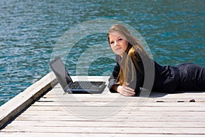 Woman with laptop and sea