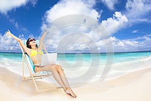 woman with laptop on the tropical beach