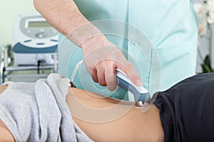 Woman during laser physiotherapy