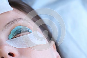 Woman on lash lifting laminating procedure in beauty clinic with close eyes.