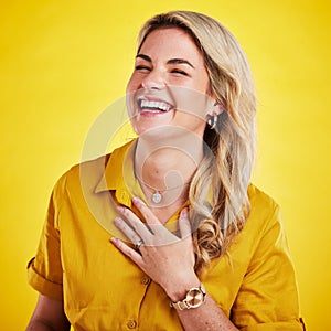 Woman, laughing and happy in studio with joke, comedy or funny reaction against gradient yellow background. Comic