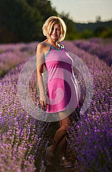 Woman in lavender field at sunset