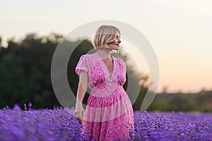 Woman in lavender field at sunset