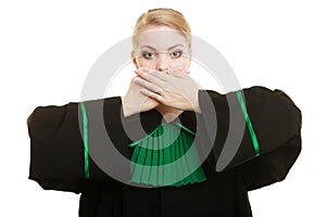 Woman lawyer barrister covering mouth with hands.