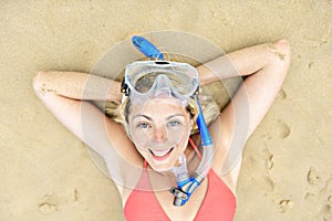 Woman lay with mask for snorkling at the seaside