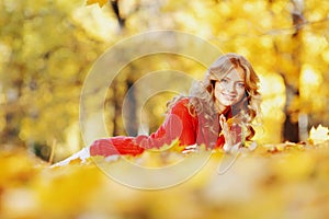 Woman laying on autumn leaves