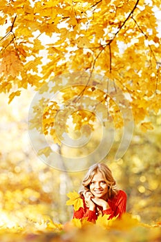 Woman laying on autumn leaves