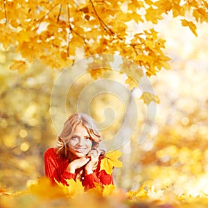 Woman laying on autumn leaves