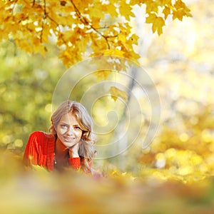 Woman laying on autumn leaves