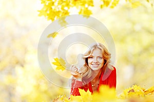 Woman laying on autumn leaves