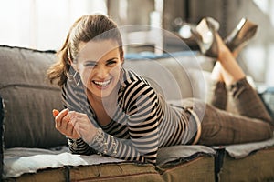 Woman laying on divan in loft apartmen