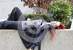 Woman laying down on stone flower bed