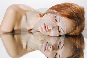 Woman laying on the mirror