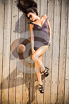 Woman laying on wood deck