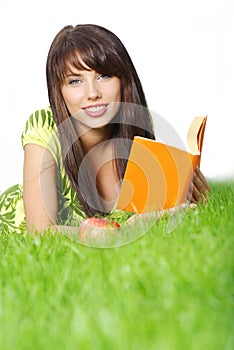 woman lays on green field