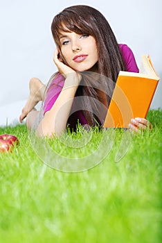 Woman lays on green field