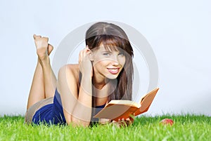 Woman lays on green field