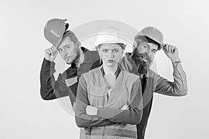 Woman, leader in hard hat with serious face stand