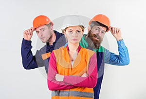 Woman, leader in hard hat with serious face stand