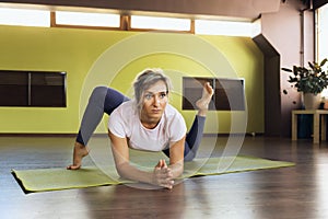A woman leading a healthy lifestyle, doing yoga in the studio