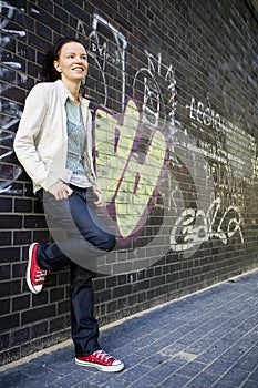 Woman leaning against a wall