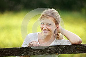 Woman leaning on fence