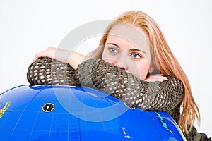 Woman leaning on globe