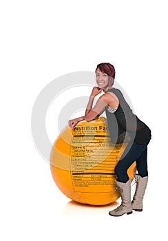 Woman Leaning on Orange with Nutrition Label