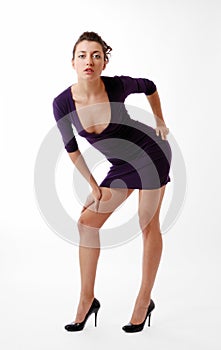 Woman leaning over in skinny dress with decollete photo