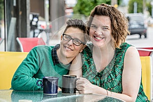 Woman leaning on shoulder of female spouse