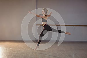 Woman leaping while performing stretching exercise
