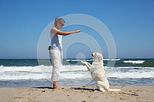 Woman learner dog on the beach