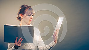 Woman learning with ebook and book. Education.