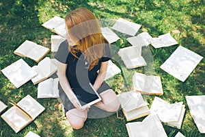 Woman learning with ebook reader and book. Choice between modern educational technology and traditional way method. Girl holding d