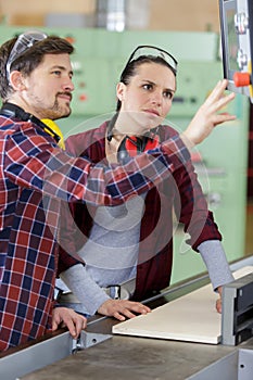 woman learning how to operate industrial machine