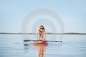 Woman learning to paddleboard